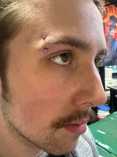Eyebrow piercing by Briana