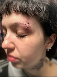 Eyebrow piercing by Briana