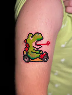 Pixel-art Pac-Man and ghost tattoo by Dave