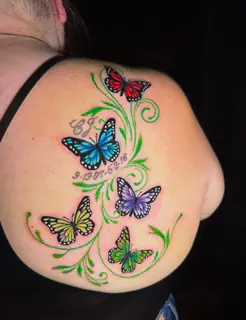 Color abstract Freedom lettering tattoo across an upper back