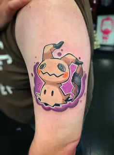 Black geometric symbol tattoo with pink and teal watercolor accents