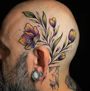 Botanical olive branch tattoo on a forearm
