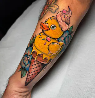 Pixel-inspired blue hero tattoo on an upper arm