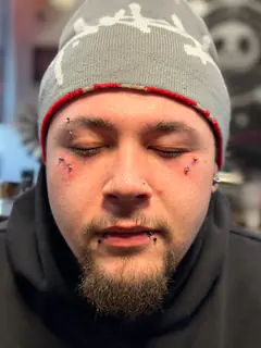 Eyebrow and facial piercings completed by Mikey