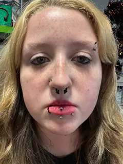Multiple nose and lip piercings completed by Mikey