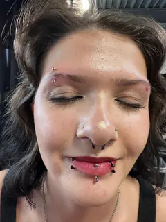 Multiple facial piercings completed by Mikey