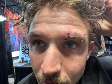 Eyebrow and nose piercings completed by Mikey