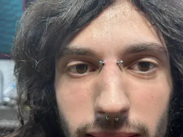 Bridge and septum piercings completed by Mikey