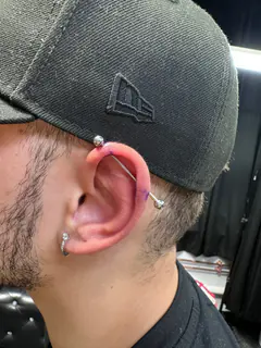 Industrial and cartilage ear piercings completed by Mikey